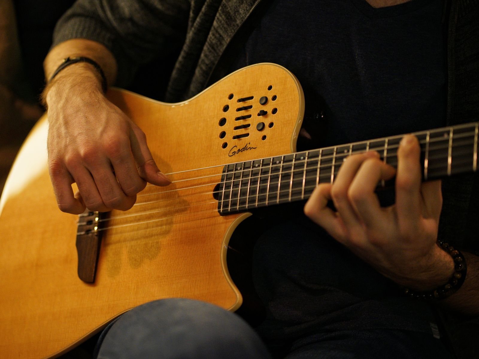 Stock photo: hands playing a string instrument in warm light